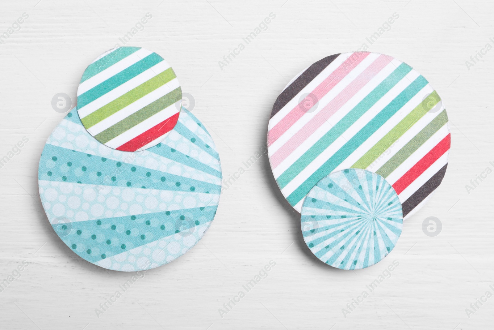 Photo of Big and small colorful paper circles on white wooden background, flat lay. Pareto principle concept