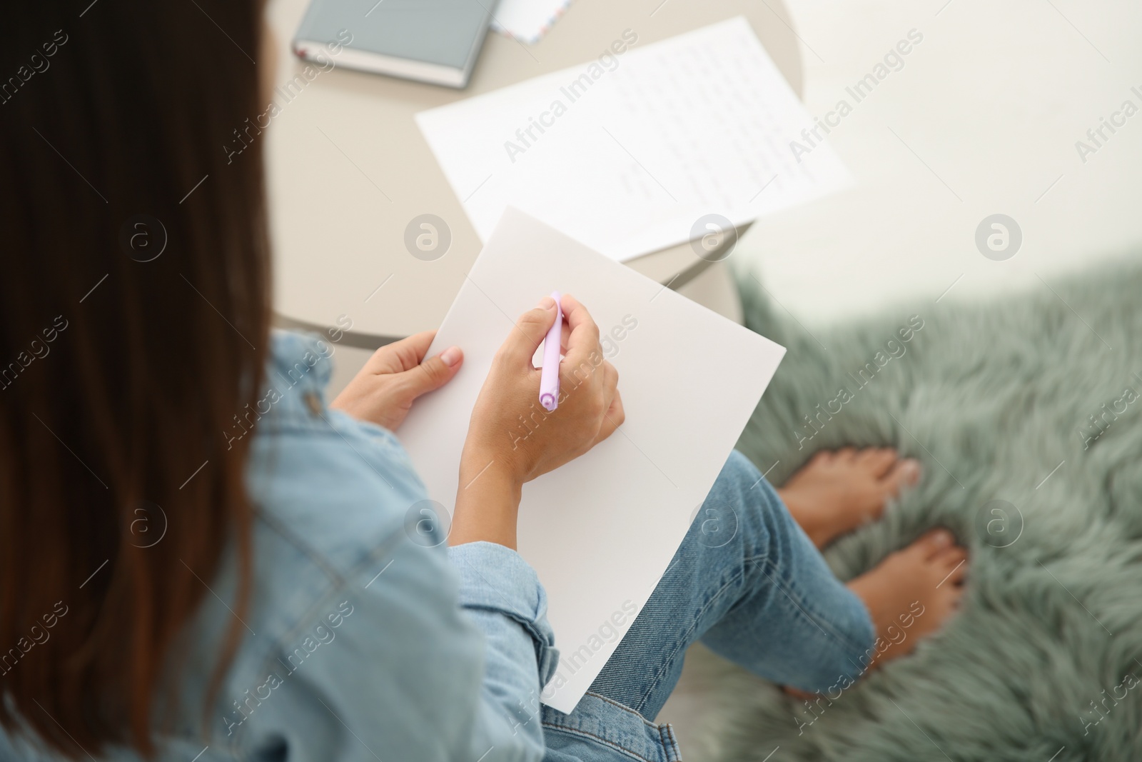 Photo of Woman writing letter at home, closeup view