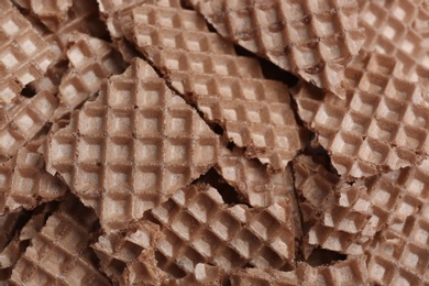 Photo of Tasty crushed wafers as background, closeup. Crispy food
