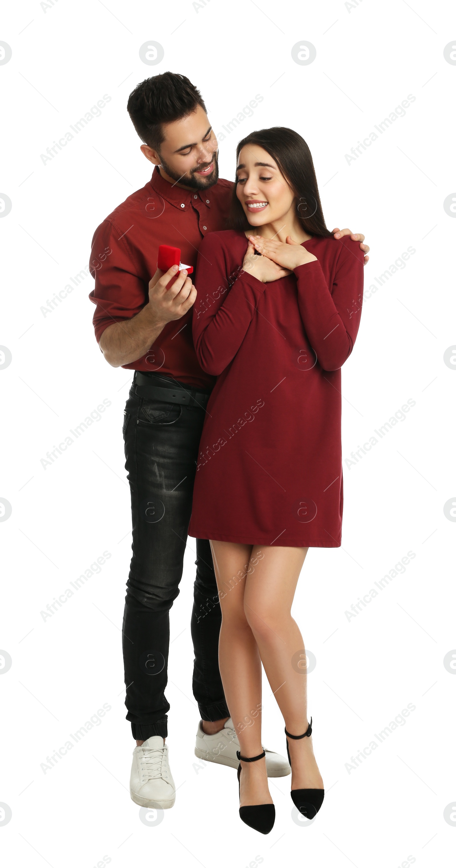 Photo of Man with engagement ring making marriage proposal to girlfriend on white background