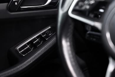 Photo of Inside of modern black car, closeup view