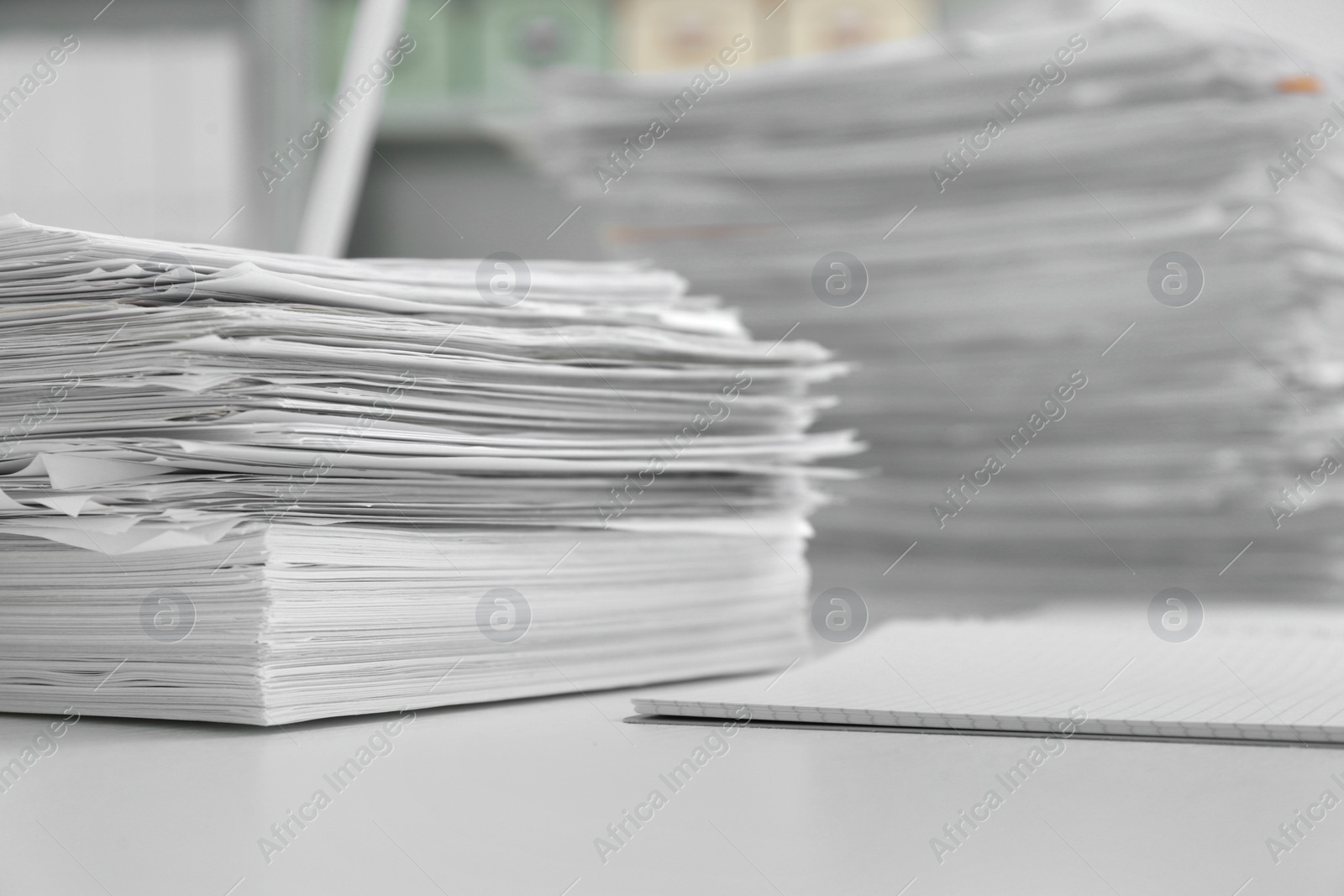 Photo of Stacks of documents on table in office