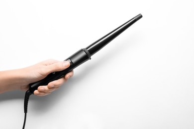 Photo of Woman holding clipless curling hair iron on white background, closeup