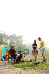 Photo of People resting near camping tent in wilderness