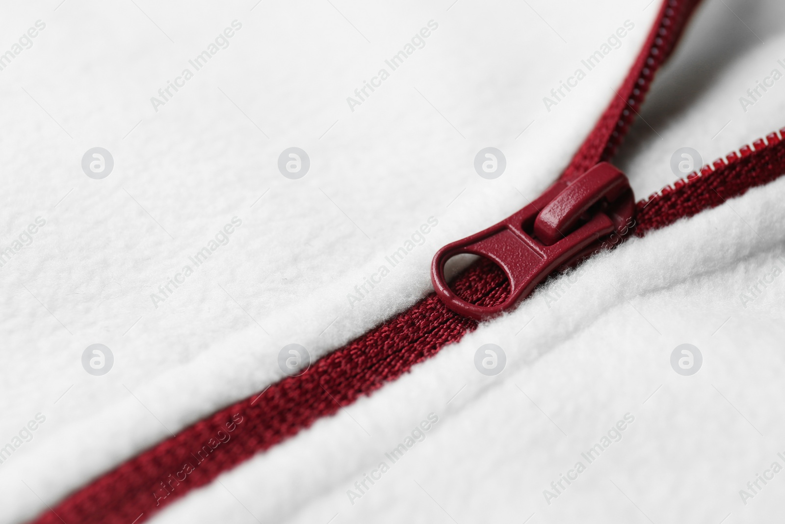 Photo of White woolen sweatshirt with zipper as background, closeup view