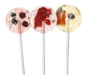 Photo of Sweet colorful lollipops with berries on white background