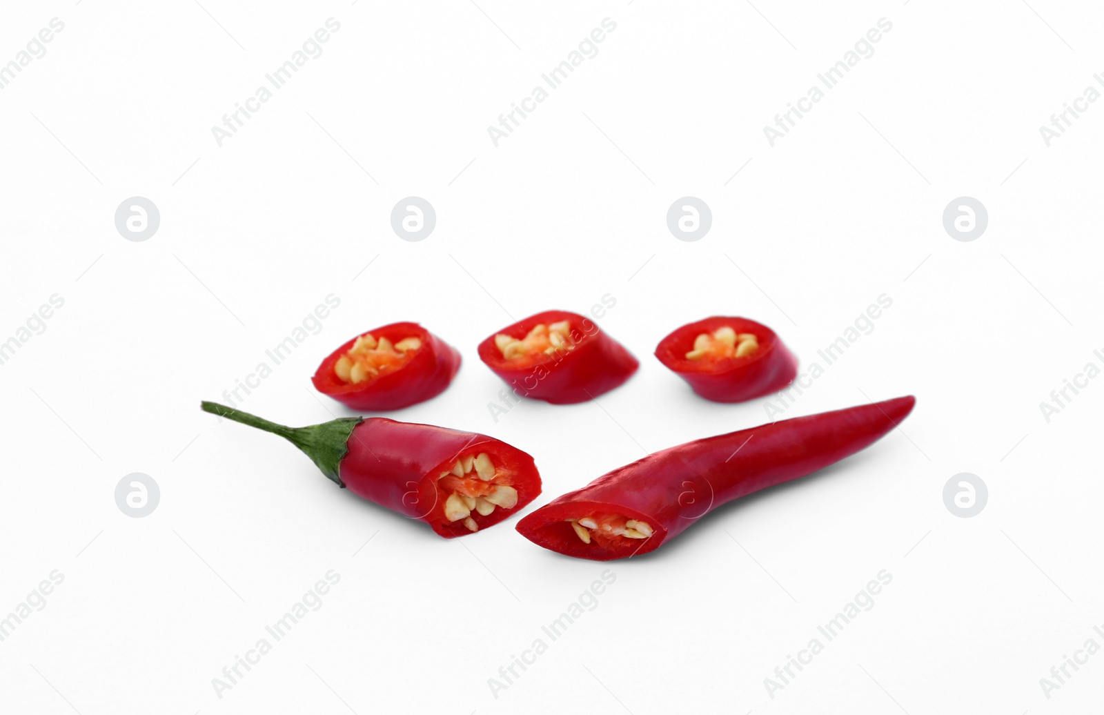 Photo of Cut red hot chili peppers on white background
