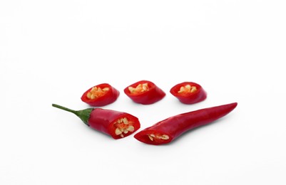 Photo of Cut red hot chili peppers on white background