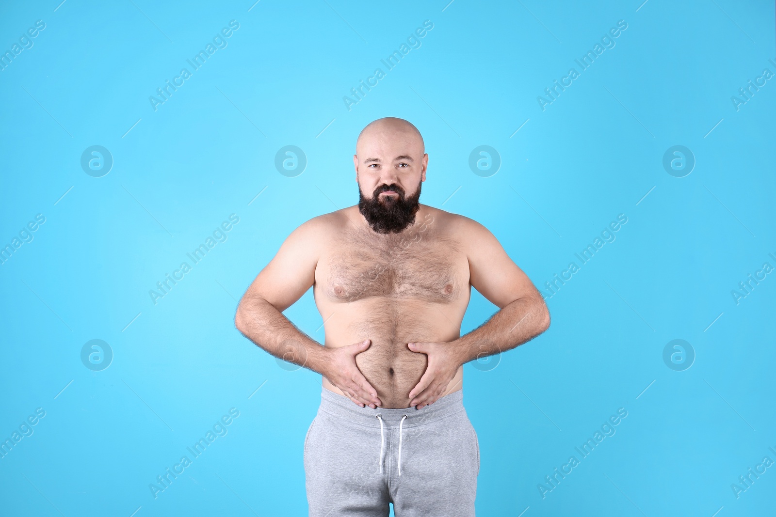 Photo of Fat man on color background. Weight loss