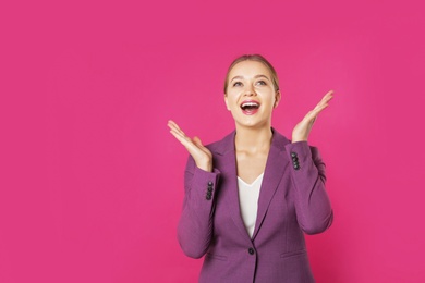 Portrait of emotional young businesswoman on color background. Space for text