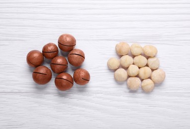 Photo of Delicious Macadamia nuts on white wooden table, flat lay