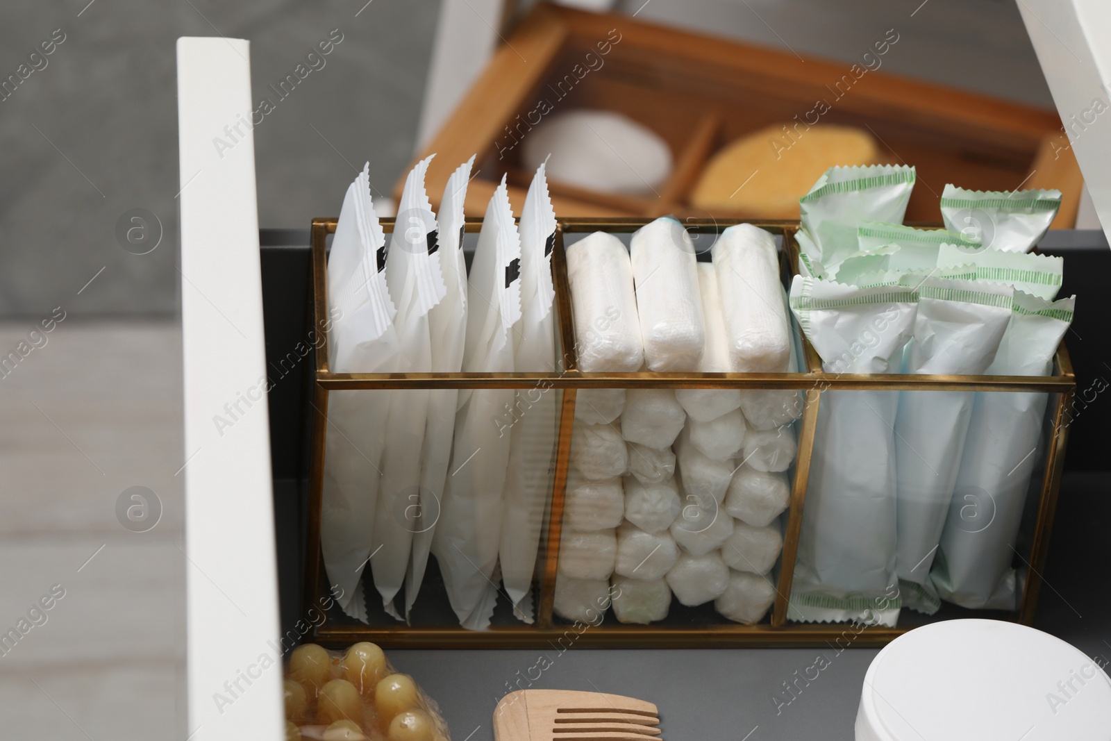Photo of Storage of different feminine hygiene products in drawer, closeup