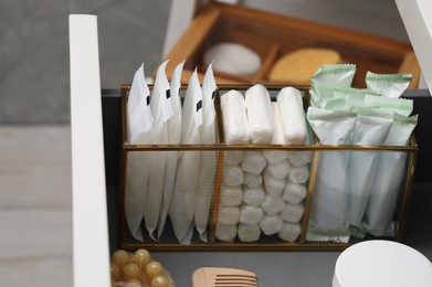 Storage of different feminine hygiene products in drawer, closeup