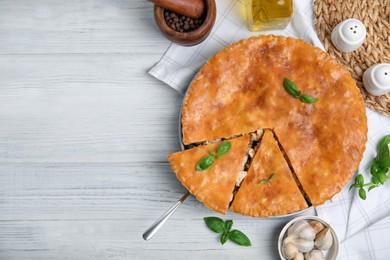 Photo of Delicious meat pie served on white wooden table, flat lay. Space for text