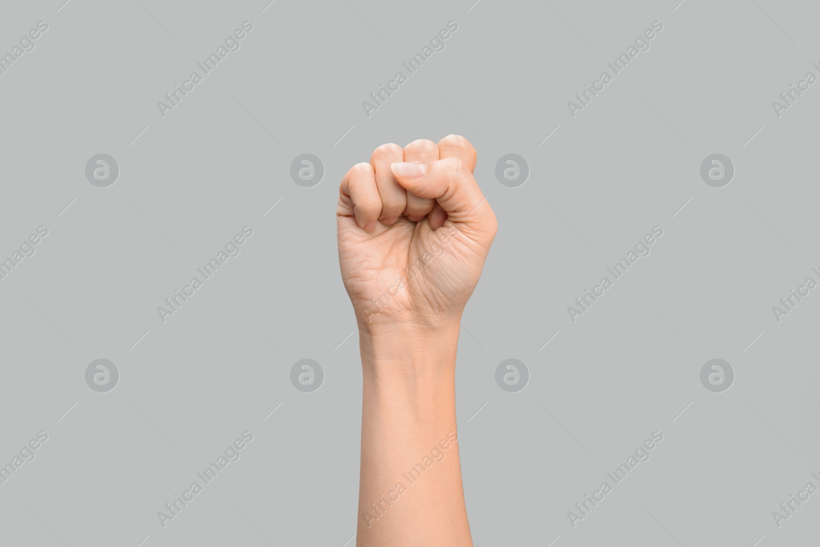 Photo of Woman showing S letter on grey background, closeup. Sign language