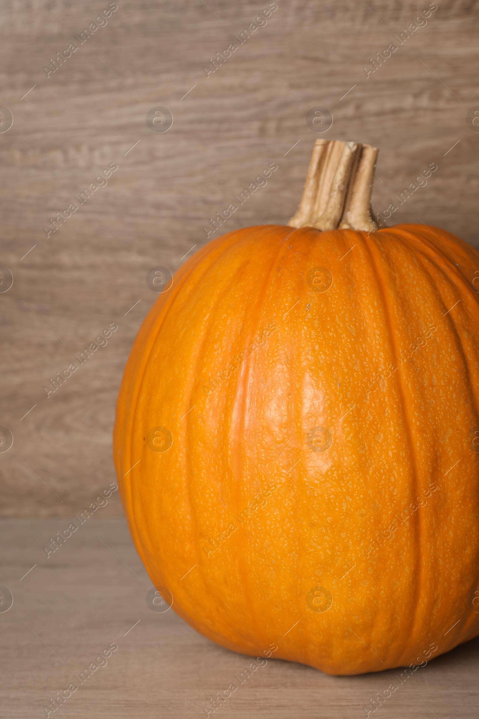 Photo of Fresh ripe pumpkin on wooden table, closeup