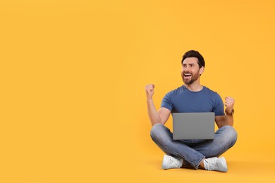 Photo of Emotional man with laptop on yellow background. Space for text