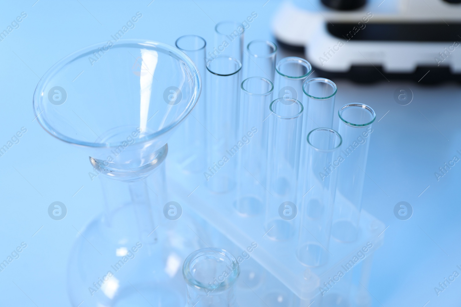 Photo of Laboratory analysis. Different glassware on white table, closeup