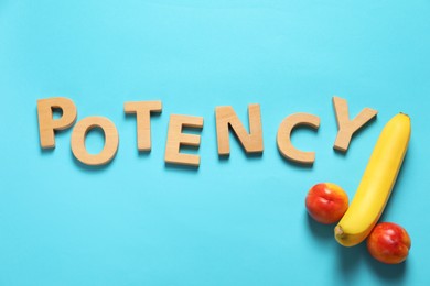 Photo of Word Potency madewooden letters near banana and nectarines symbolizing male genitals on light blue background, flat lay