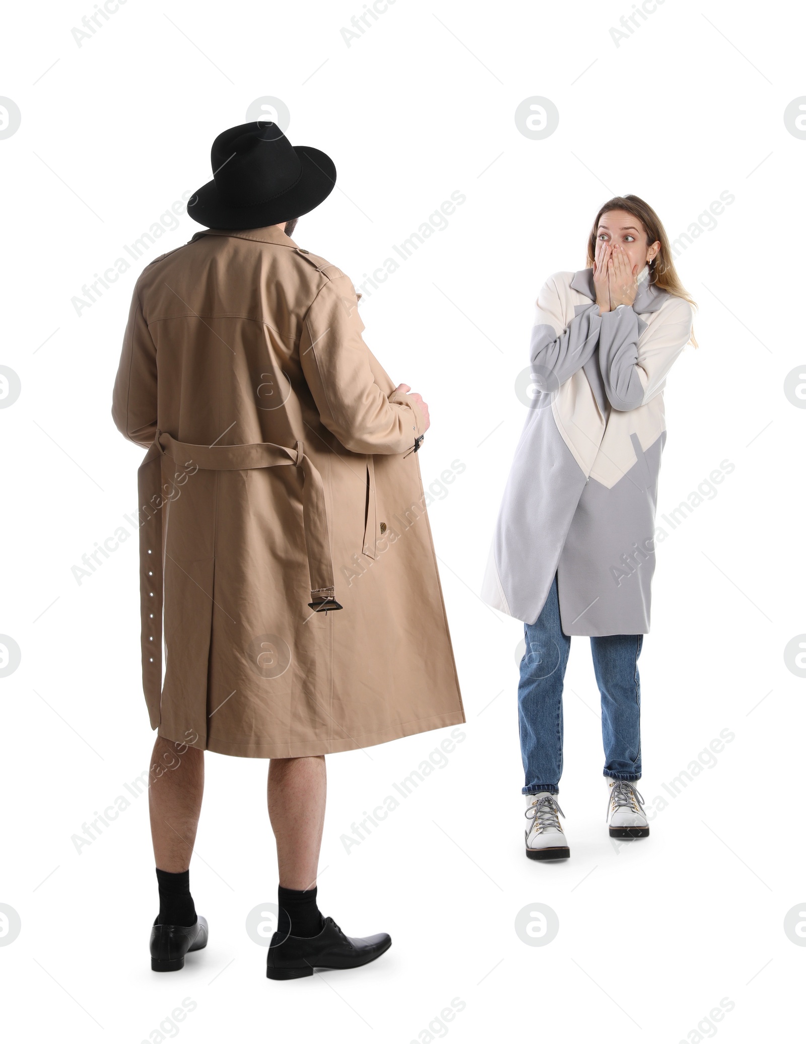 Photo of Exhibitionist exposing naked body under coat in front of young woman isolated on white