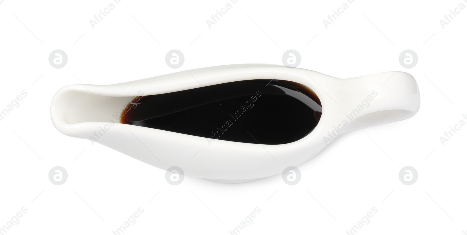 Photo of Tasty soy sauce in gravy boat isolated on white, top view