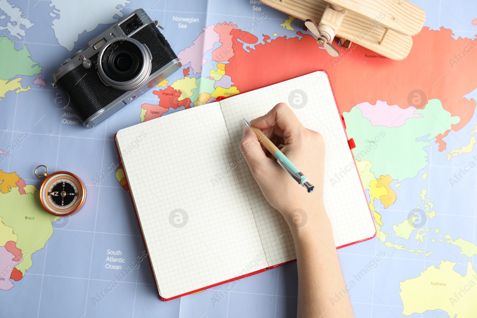 Photo of Woman planning vacation on world map, top view with space for text. Travel agency