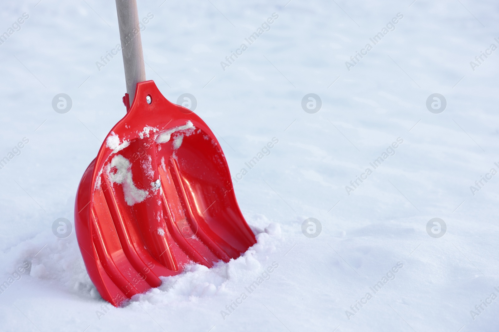 Photo of Snow shovel with wooden handle outdoors. Space for text