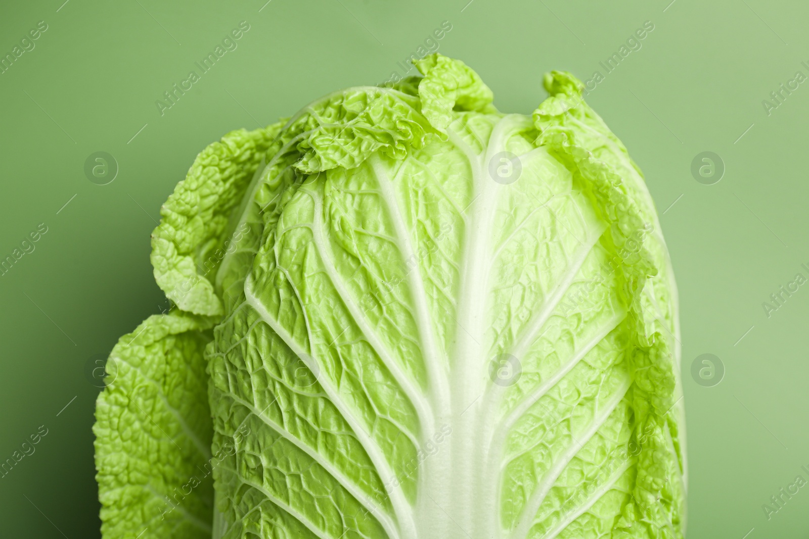 Photo of Fresh ripe Chinese cabbage on pale green background, top view