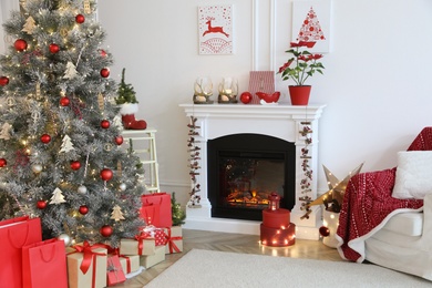 Living room with fireplace and Christmas decorations. Festive interior design