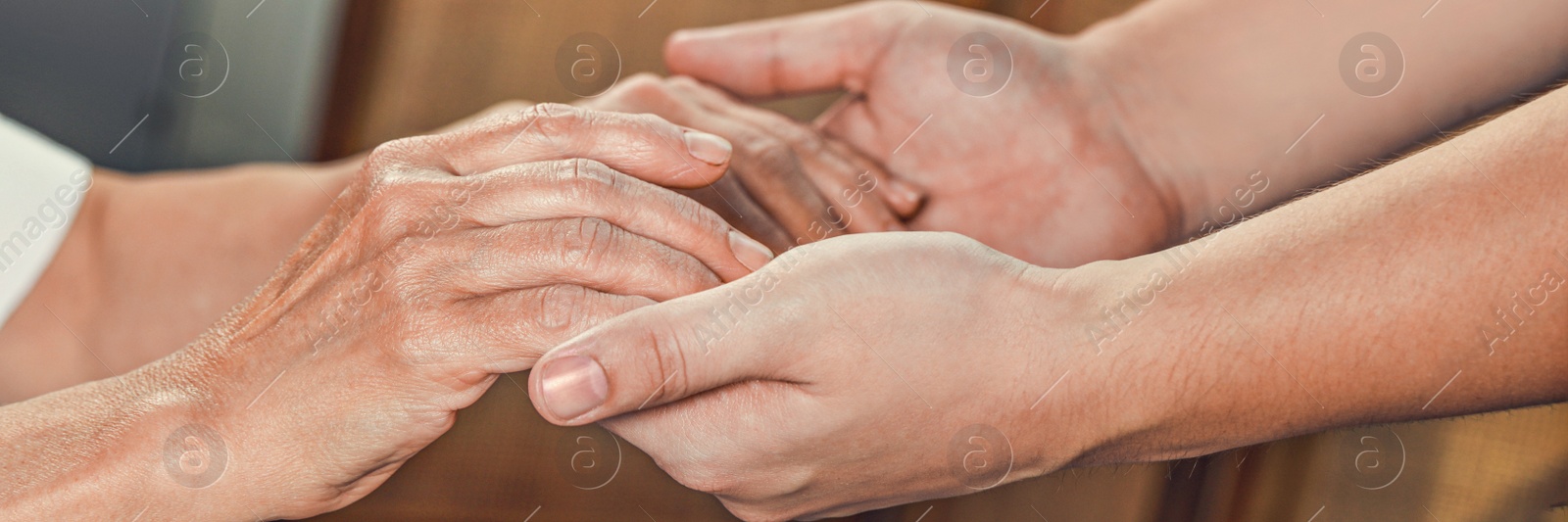 Image of Caregiver helping elderly woman at home, closeup. Banner design