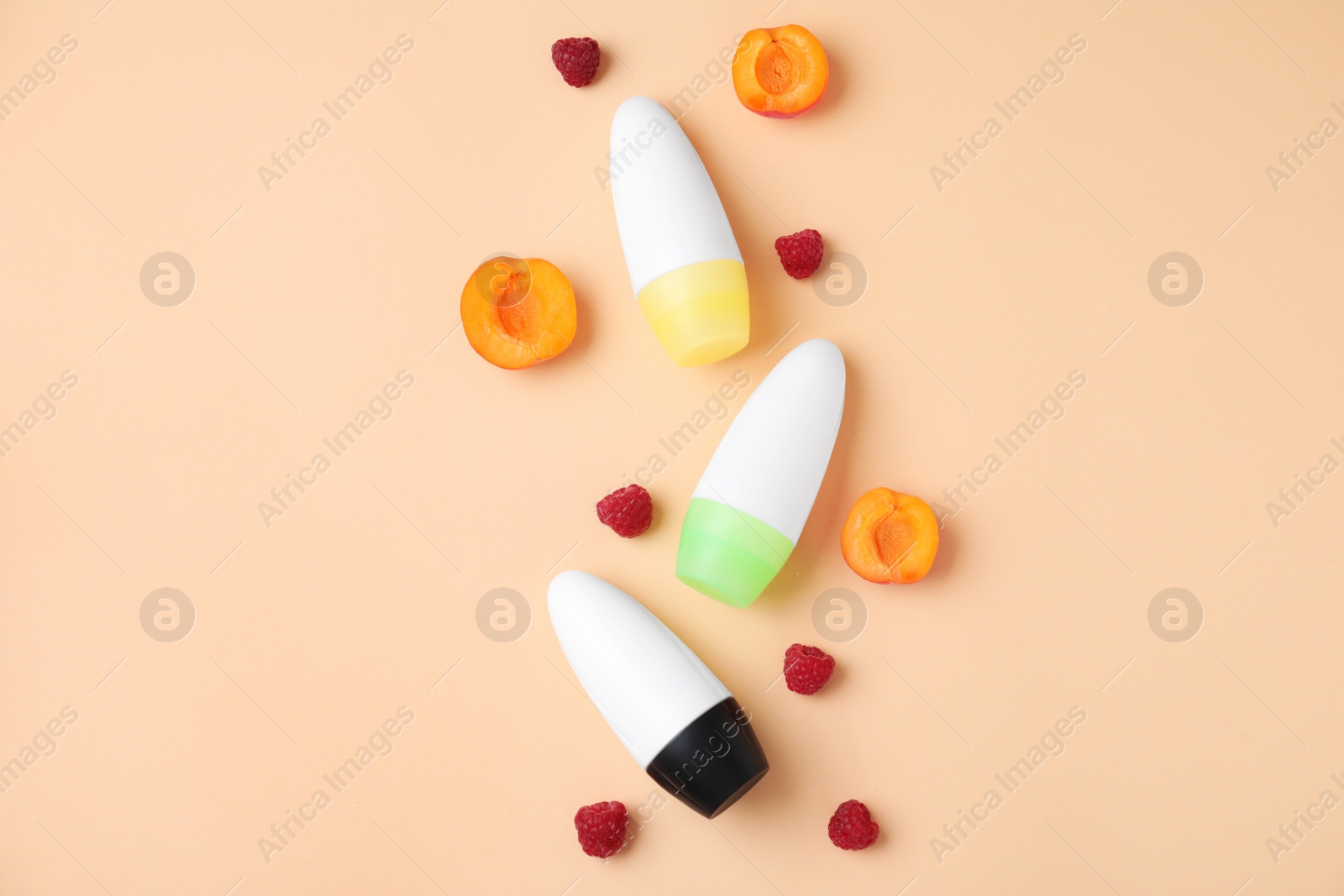 Photo of Flat lay composition with different female roll-on deodorants on beige background, space for text