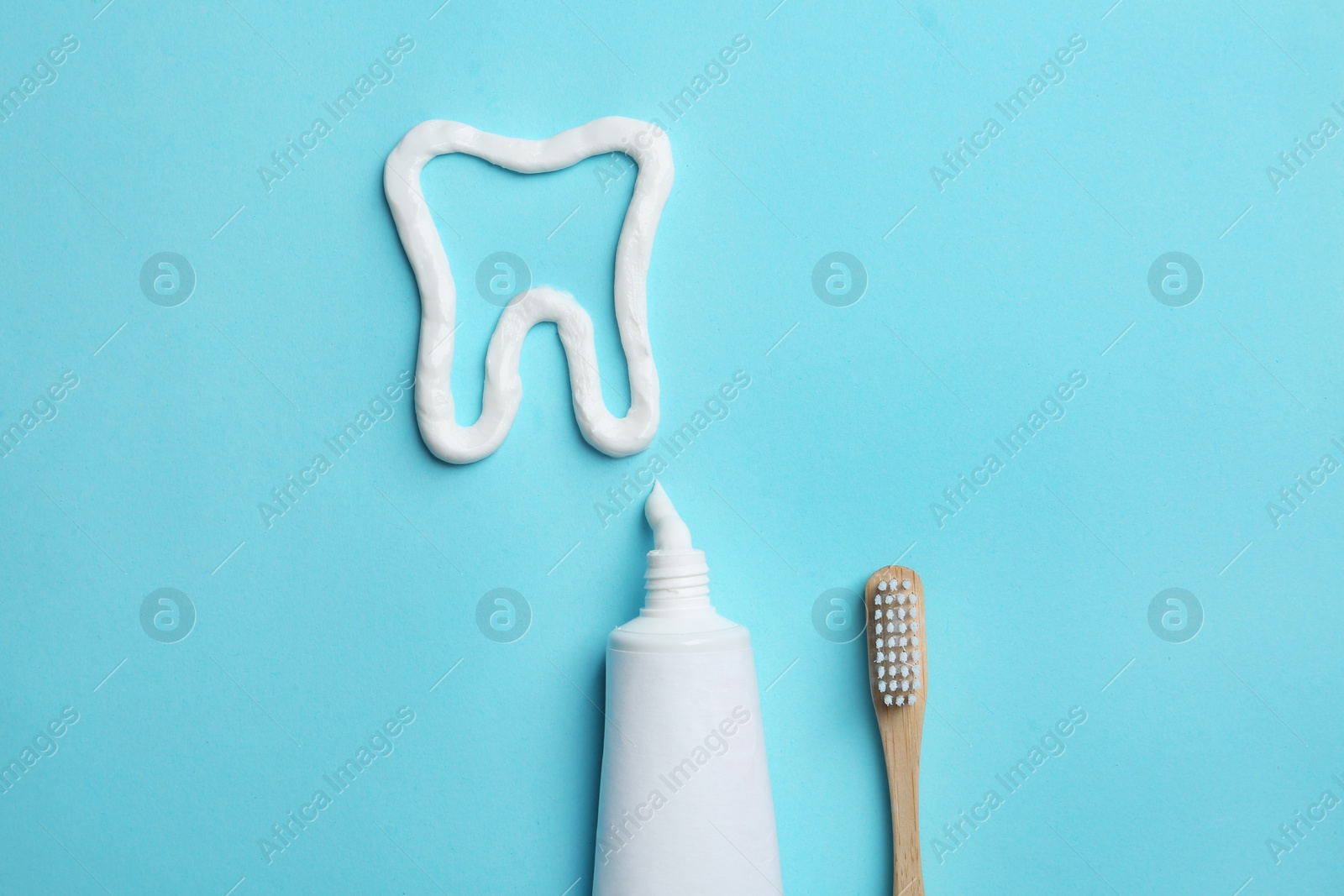 Photo of Tooth made of paste, tube, brush and space for text on color background, flat lay