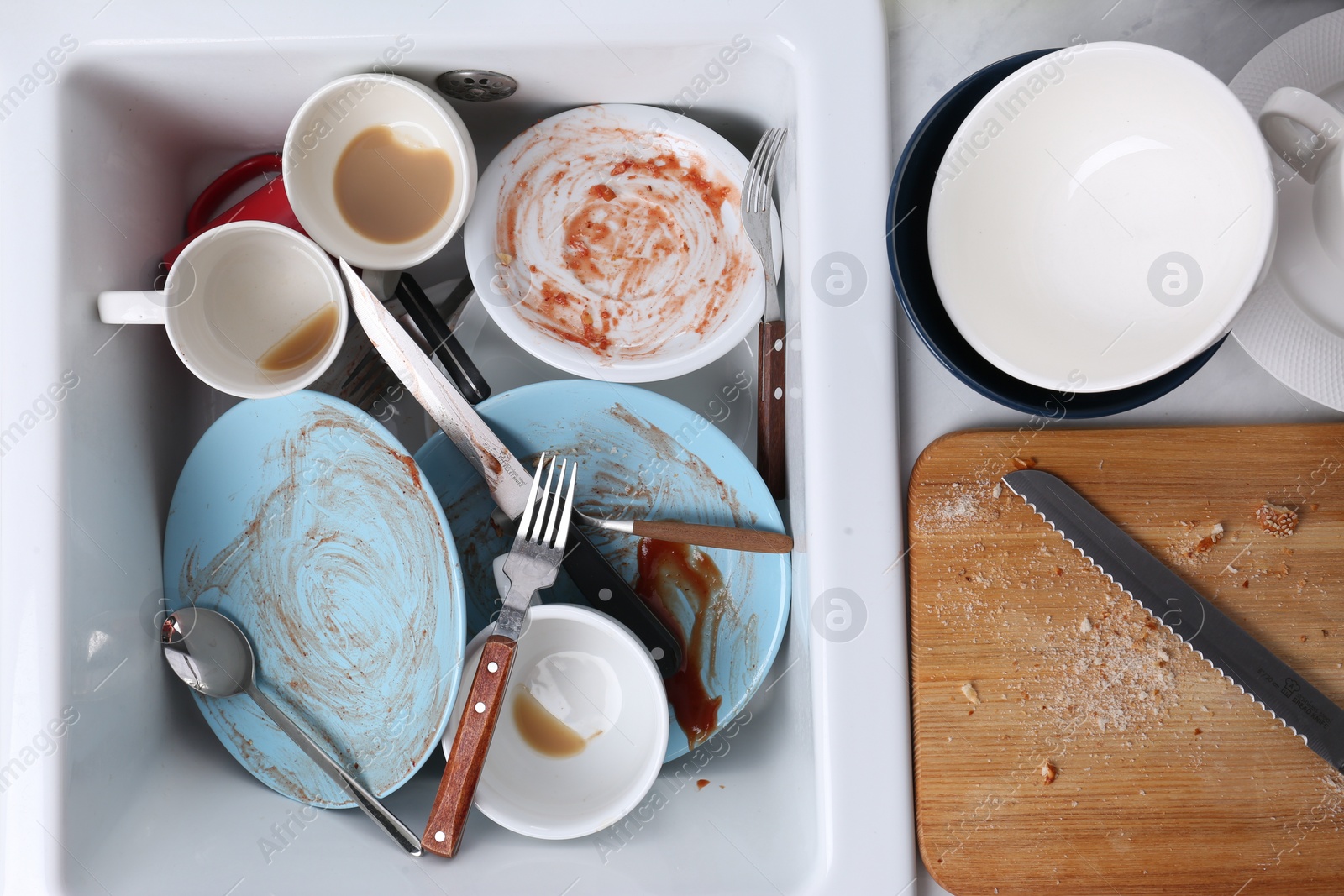 Photo of Many dirty utensils and dishware in kitchen sink, top view