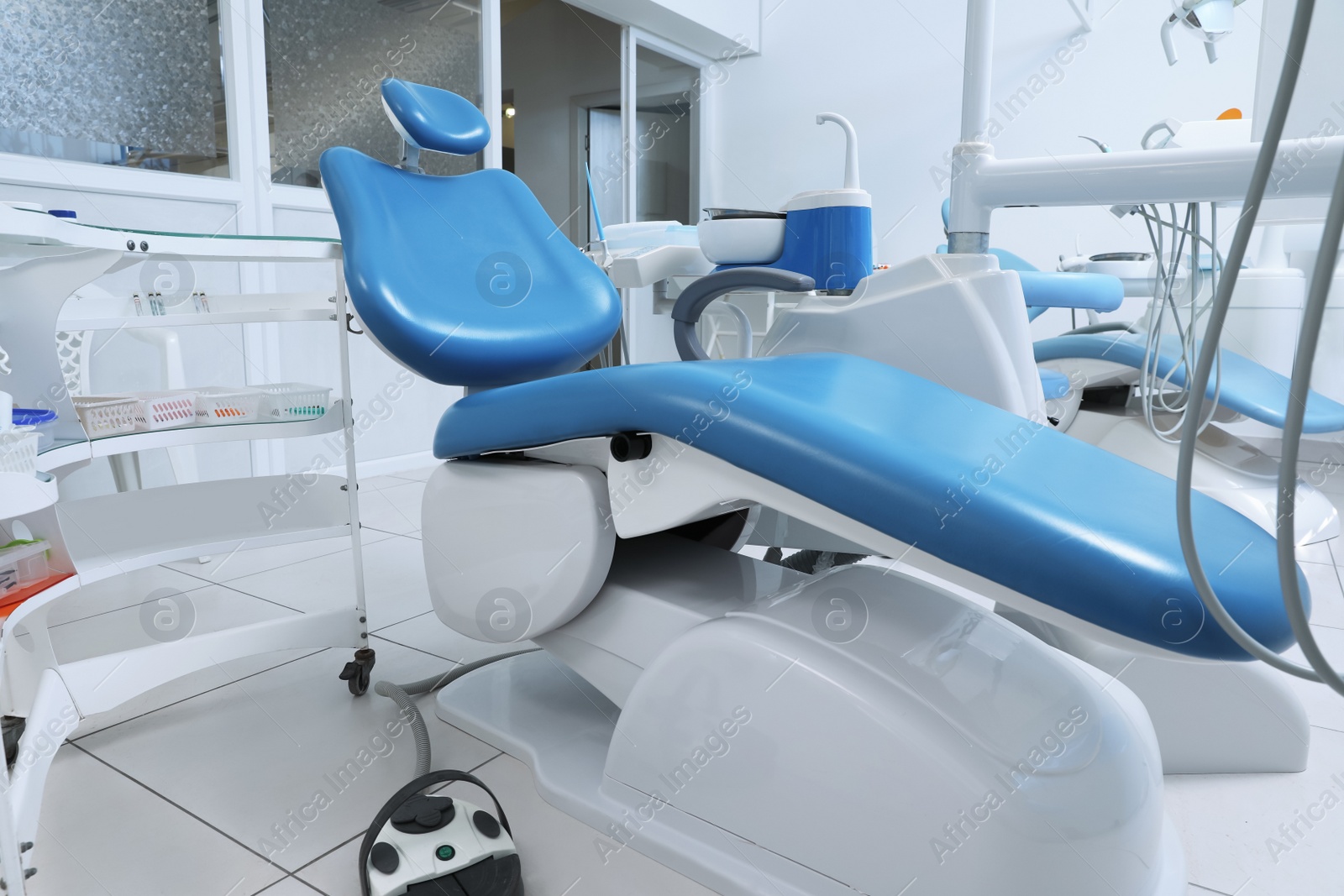 Photo of Dentist's office interior with chair and modern equipment