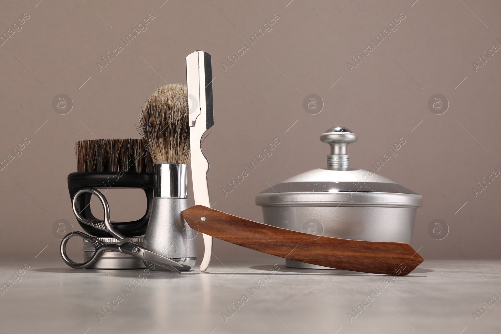 Photo of Moustache and beard styling tools on grey table