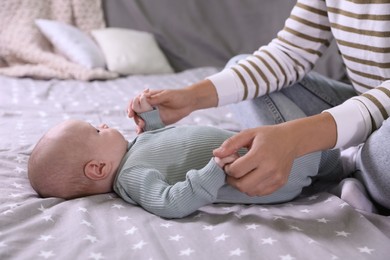 Photo of Mother and her little baby on bed, closeup