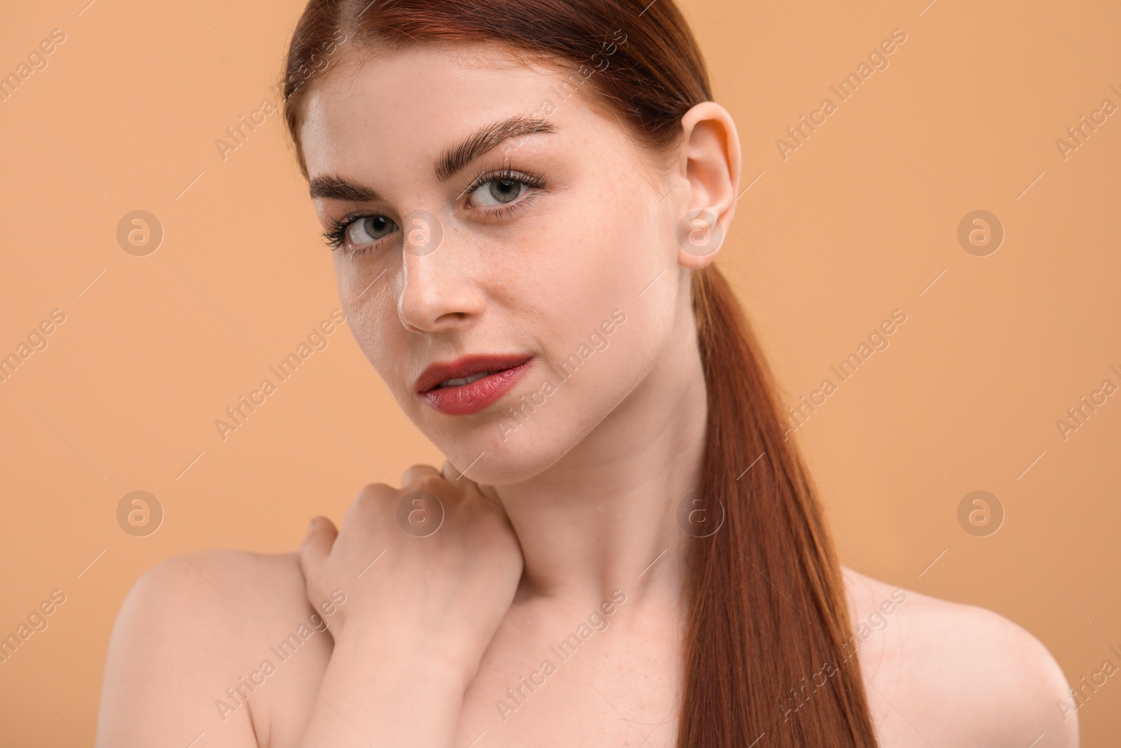 Photo of Portrait of beautiful woman with freckles on beige background