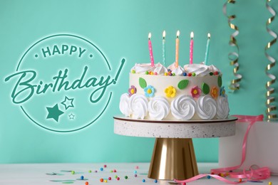 Happy Birthday! Delicious cake and party decor on white wooden table against turquoise background