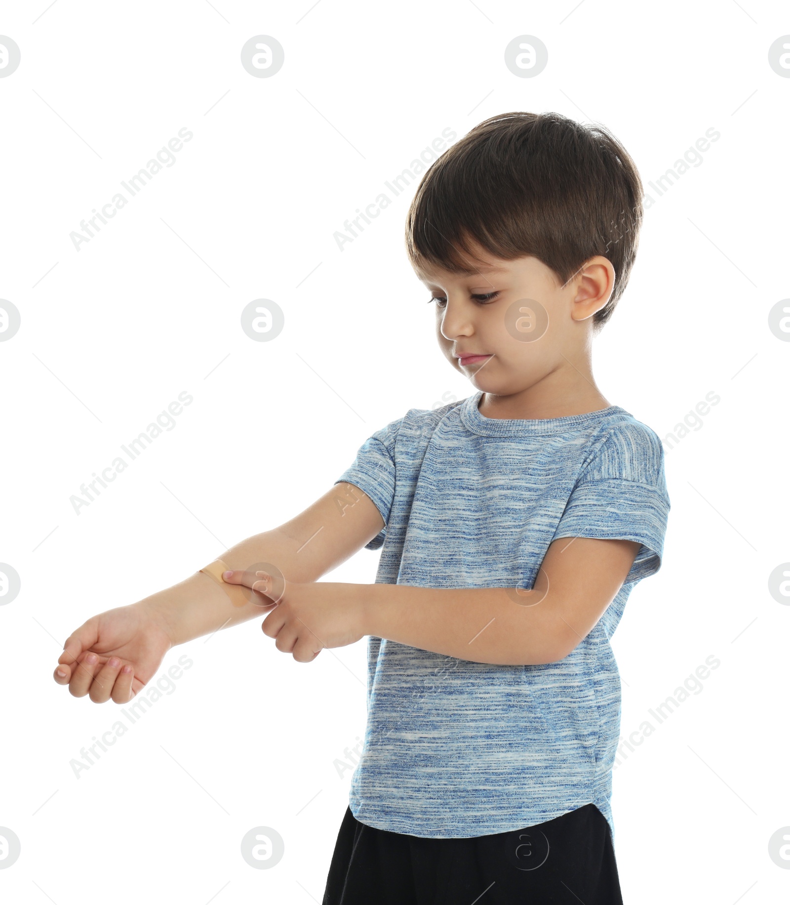 Photo of Little boy with sticking plaster on arm against white background