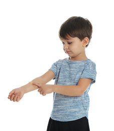 Photo of Little boy with sticking plaster on arm against white background