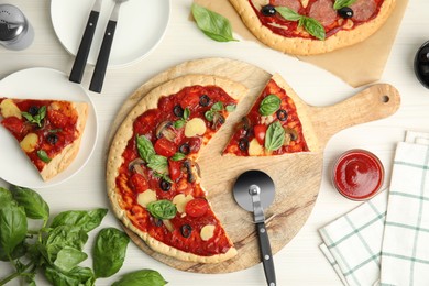 Photo of Delicious homemade pita pizza on white wooden table, flat lay