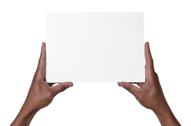 Photo of African American man holding sheet of paper on white background, closeup. Mockup for design