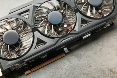 One computer graphics card on grey textured table, above view