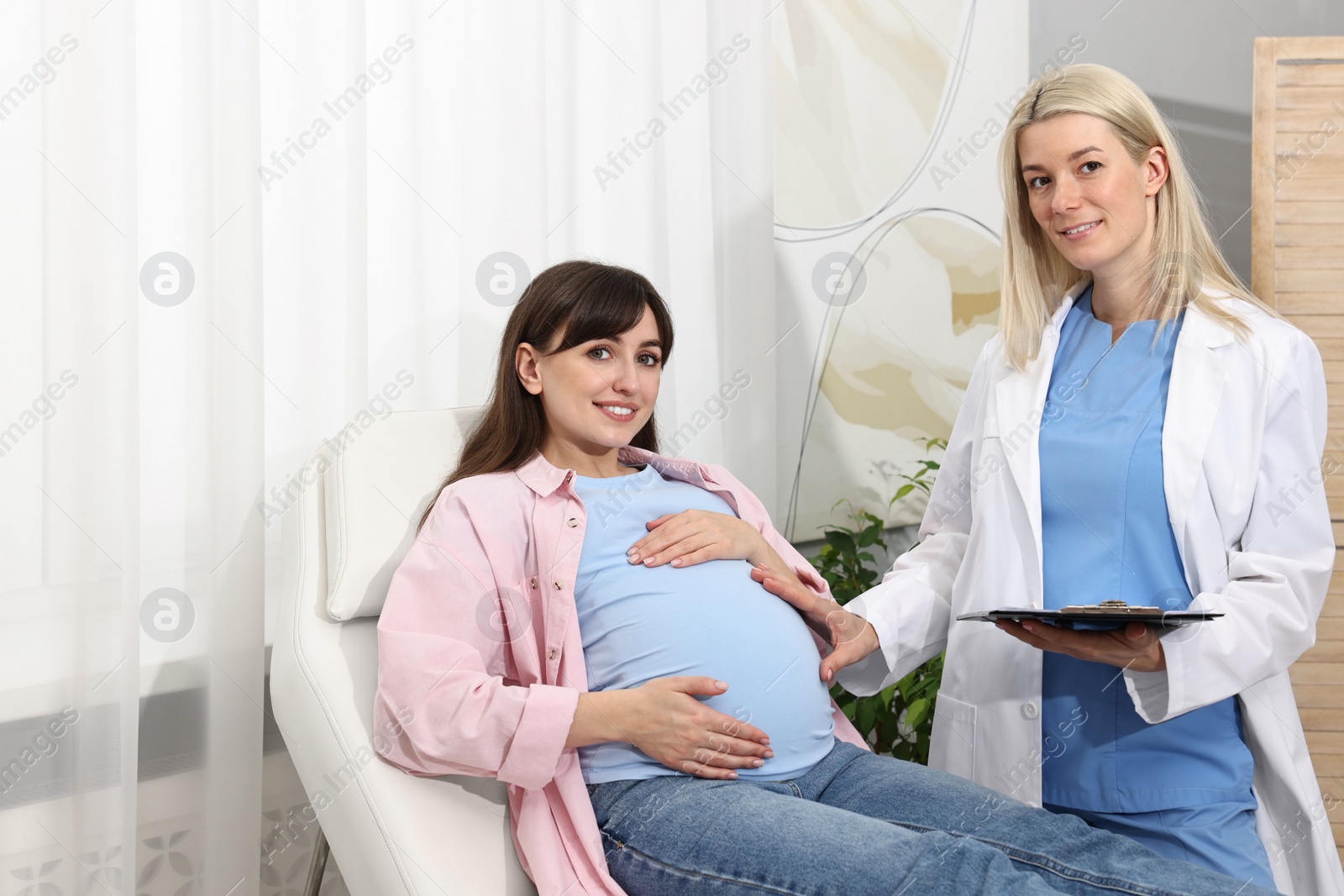 Photo of Happy pregnant woman having doctor appointment in hospital