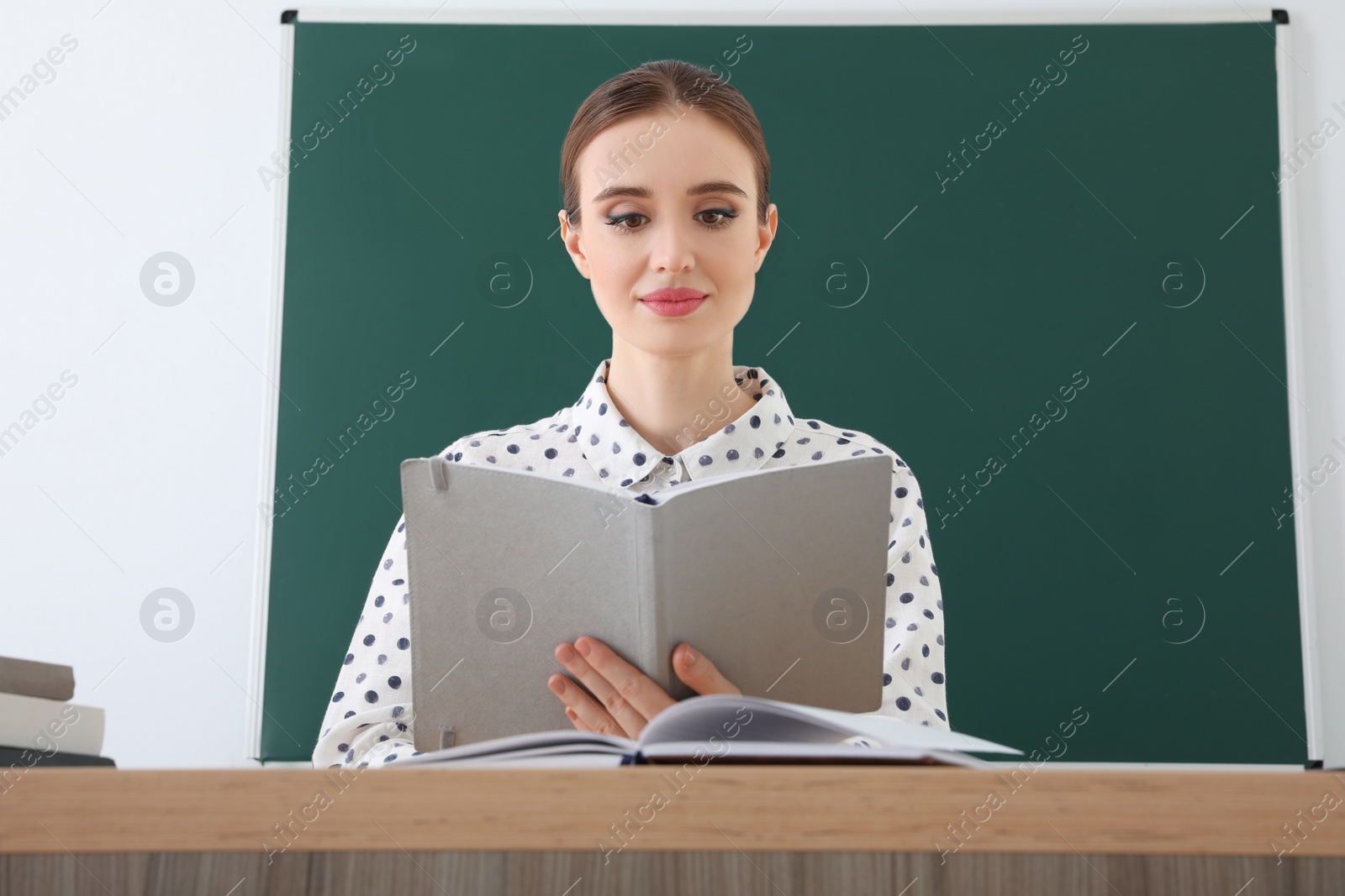 Photo of Portrait of young female teacher in classroom