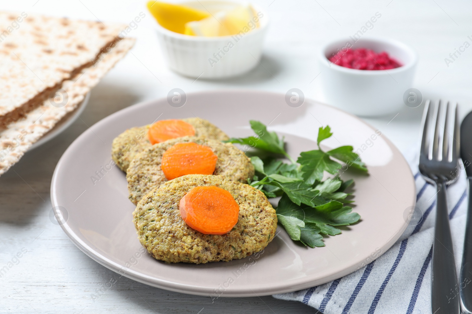 Photo of Plate of traditional Passover (Pesach) gefilte fish on wooden table