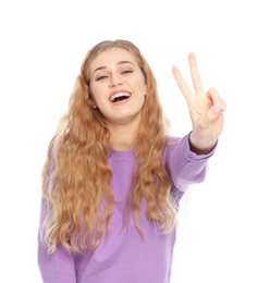 Happy young woman showing victory gesture on white background