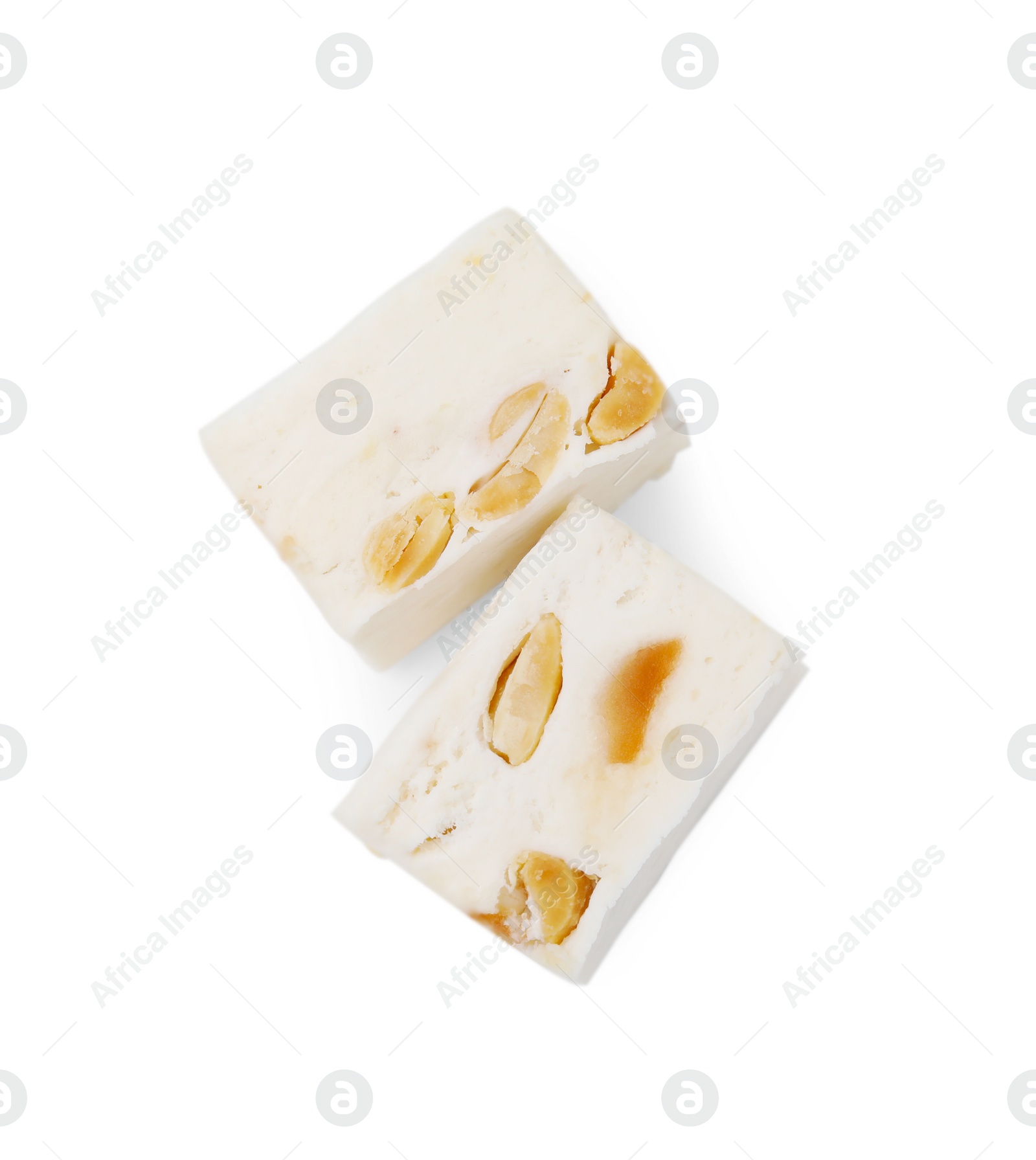 Photo of Pieces of delicious nougat on white background, top view