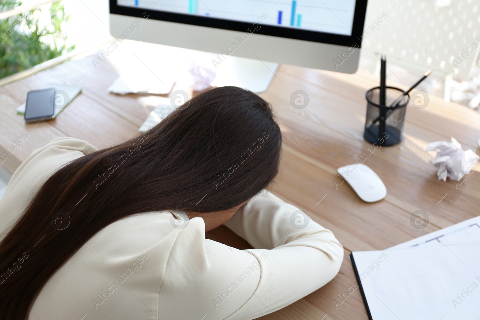 Photo of Stressed out businesswoman at workplace in office, above view