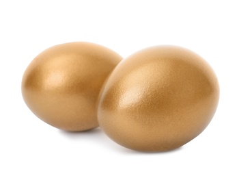 Two shiny golden eggs on white background